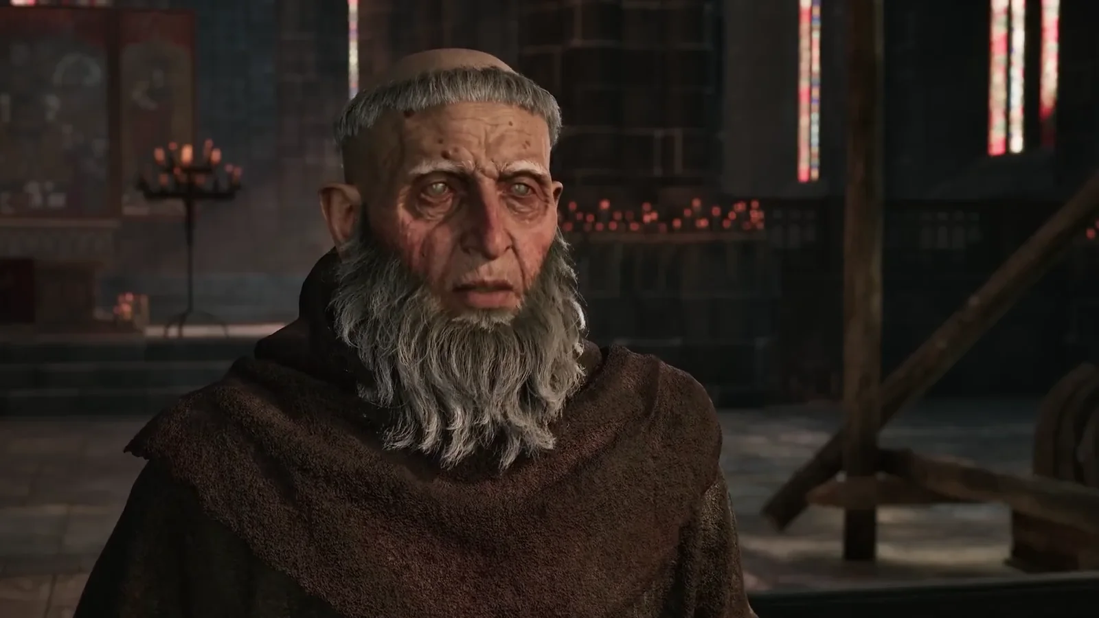 Father Florin speaks inside a candlelit church